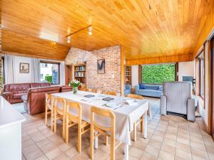 a large living room with a table and chairs at La Paix in Sint-Idesbald