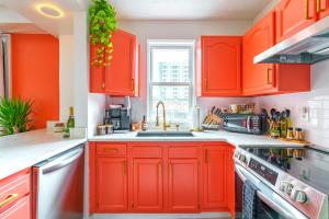 a kitchen with orange cabinets and a sink at Prime Location Top Rated Clean Parking Free! in Columbus +56 photos