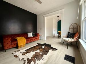 a living room with a couch and a rug at Short North Convention King Bed Free Parking! in Columbus