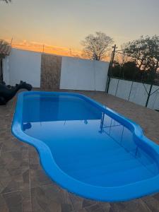a blue swimming pool on top of a patio at Chácara por do Sol in Campinas