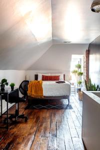 a bedroom with a bed on top of a wooden floor at Short North Convention Private Parking Pets! in Columbus