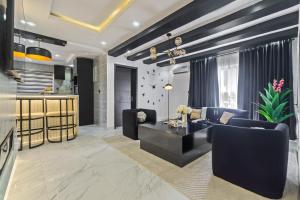 a living room with a couch and a table at Noir & Blanc Suite in Mama