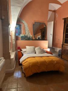 a bedroom with a large bed with a large mirror at Antiche Scuderie Palazzo Fasciani in Sulmona