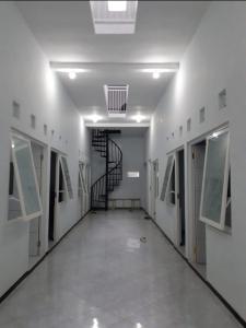 a hallway with a spiral staircase in a building at Sewindu in Ramekasan