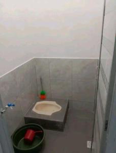a small bathroom with a sink in a stall at Sewindu in Ramekasan