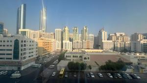 a city with cars parked in a parking lot at XD Cozy Apartments in Abu Dhabi
