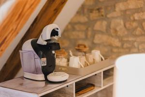 a coffee maker sitting on top of a shelf at Hostellerie des Princes-Evêques - Le Donjon in Porrentruy