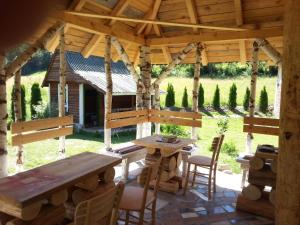 a wooden pavilion with a wooden table and chairs at Staparski Sorrento in Užice