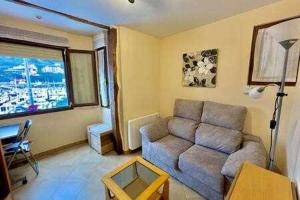 a living room with a couch and a table at Kai Etxea , el mismo puerto de Bermeo in Bermeo