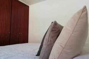 two pillows sitting on a bed in a bedroom at Casas Galloway - Playa Santiago Sol y descanso in Playa de Santiago