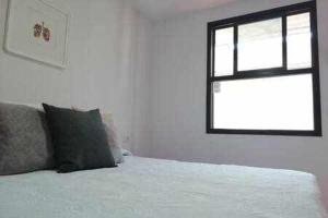 a bedroom with a bed and a window at Casas Galloway - Playa Santiago Sol y descanso in Playa de Santiago