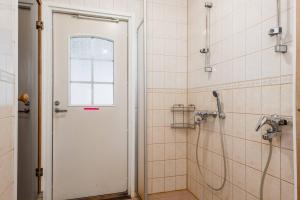 a bathroom with a shower with a glass door at CYV - A unique Villa on a Lake in Karhoinen +32 photos