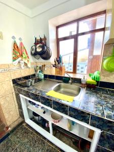 a kitchen counter with a sink and a window at Two-Story San Blas Home with Terrace and Stunning Views in Cusco