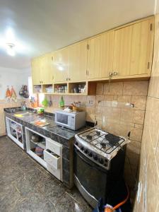 a kitchen with a stove and a counter top at Two-Story San Blas Home with Terrace and Stunning Views in Cusco