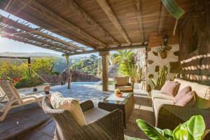 a patio with a couch and chairs and a table at Casa Oronado in Ingenio