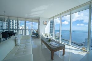 a living room with a white couch and large windows at Lavish Condo Breathtaking Views in Miami