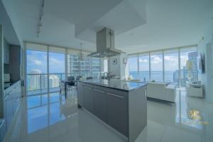a large white kitchen with a view of the city at Lavish Condo Breathtaking Views in Miami