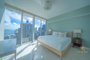 a bedroom with a bed and a large window at Lavish Condo Breathtaking Views in Miami +31 photos