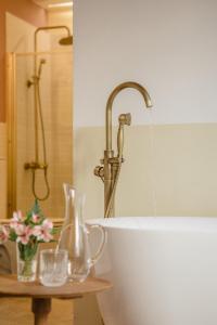 a bathroom with a bath tub with a water fountain at La Noire Petit hotel in Buenos Aires