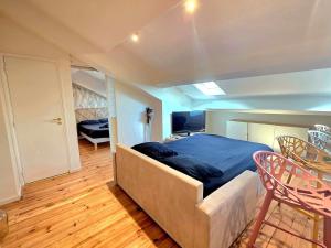 a bedroom with a bed and a table and chairs at Design et confort - Nice Centre 4 pers in Nice +10 photos