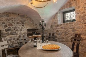 a dining room with a table and a stone wall at doLodge homestead in the Kolpa River canyon in Stari Trg ob Kolpi +20 photos