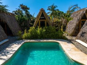 a swimming pool in front of a resort at Villa Privada Merkaba Pxm in Brisas de Zicatela