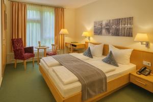 a hotel room with a large bed in a room at Schlosshotel Eyba in Saalfeld +19 photos