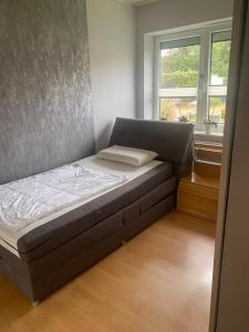 a small bed in a room with a window at Haus Sommerfeld 