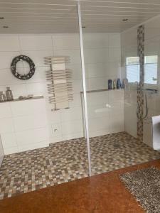 a bathroom with a shower with a glass door at Haus Sommerfeld  +14 photos