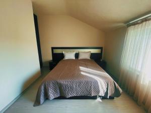 a bedroom with a large bed in a room at Lucy in Sandanski