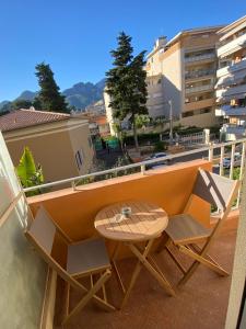 a table and bench on a balcony with a view at La Casetta Serena, Climatisé, Wifi, proche plage in Menton