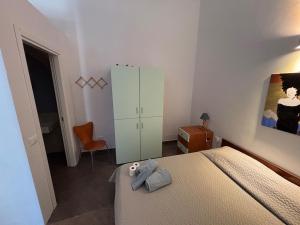 a bedroom with a bed with a stuffed animal on it at Casa in Pineta in Follonica