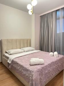 Postel nebo postele na pokoji v ubytování Olive Dream Apartment with Balcony View