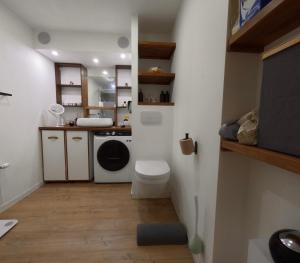a small bathroom with a toilet and a sink at Chambre privee in Noisy-le-Sec