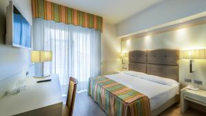Postel nebo postele na pokoji v ubytování Hotel Vittoria