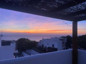 a view of a sunset from the balcony of a house at Casa Bonic -Sunset Seaview in Sant Josep de sa Talaia