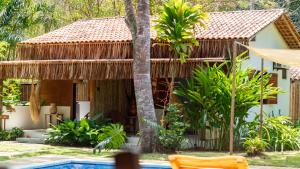 a house with a swimming pool in front of it at Villa Cacau - Floresta in Trancoso