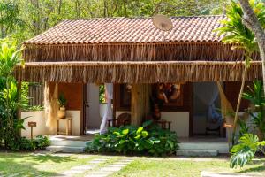 a small house with a thatched roof at Villa Cacau - Floresta in Trancoso +47 photos