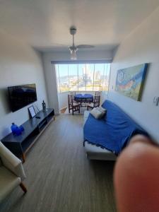 a living room with a bed and a dining room at Apartamento Dona Elvira in Piçarras