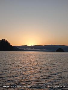 a sunset over a body of water at Cabinas Aventura in Ojo de Agua