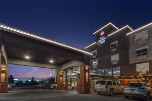 a hotel with cars parked in a parking lot at Best Western Plus West Edmonton in Edmonton