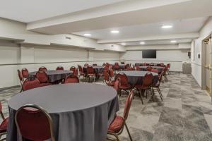 a conference room with tables and chairs and a podium at Best Western Plus West Edmonton in Edmonton +56 photos