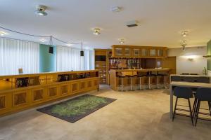 a large room with a library with a table and chairs at Aspire Frankfurt Airport, Trademark Collection by Wyndham in Rüsselsheim