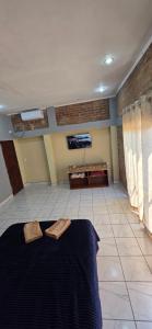 a room with a bed and a flat screen tv at La Reina in Eldorado