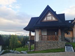 a house with a black roof at DreamHill in Bustryk