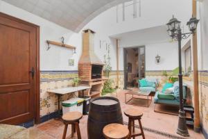 a living room with a fireplace and a table and chairs at Marina Vila House, Vista Playa in El Masnou