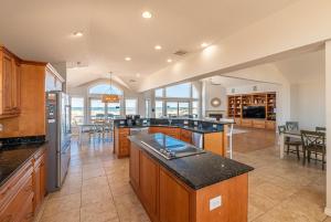 a large kitchen with an island in the middle at C9703 Oceanfront Luxury Retreat in Carova, Private Pool & Hot Tub - Prices Reduced! in Corolla