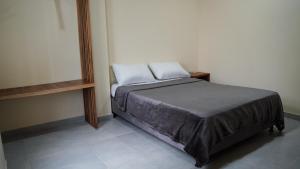 Ένα ή περισσότερα κρεβάτια σε δωμάτιο στο Nómada Private Rooms - Near Santa Marta Center