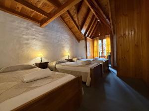 a bedroom with four beds in a room with wooden ceilings at Apart Manantial del Valle in San Martín de los Andes
