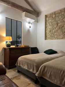 a bedroom with two beds and a dresser and a mirror at A l Aube du Midi in Bagnols-sur-Cèze +133 photos